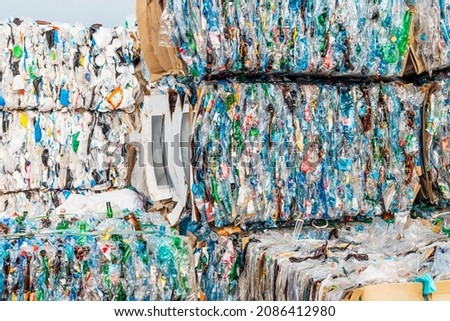 A lot of plastic garbage is compressed by a press and bound into pallets for transportation to a waste processing plant