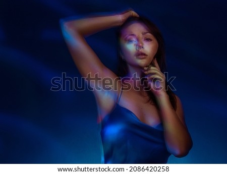 Portrait in the style of light painting. Brunette woman in blu dress long exposure photo, abstract portrait light and freezelight background