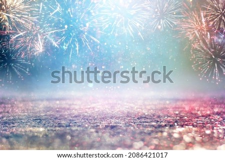 abstract gold and blue glitter background with fireworks. christmas eve, 4th of july holiday concept