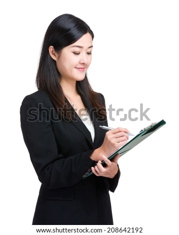 Asian businesswoman write on clipboard