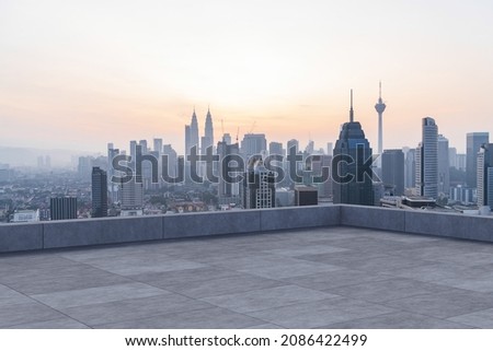 Panoramic Kuala Lumpur skyline view, concrete observatory deck on rooftop, sunset. Asian corporate and residential lifestyle. Financial city downtown, real estate. Product display mockup empty roof Royalty-Free Stock Photo #2086422499