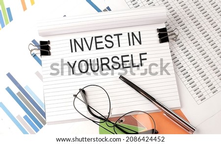 INVEST IN YOURSELF text on the chart , office supplies, business