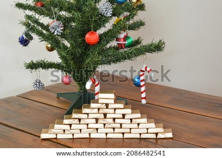 
Christmas. Decorative Christmas tree with branches in green and accessories and various types of decoration, colored balls and handmade chocolate in pyramid with golden paper, Brazil, South America o