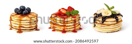 Pancakes with fruit and syrup Isolated on white background Royalty-Free Stock Photo #2086492597