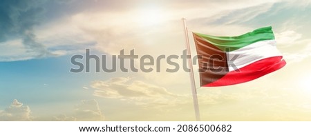 Kuwait national flag waving in beautiful sky. Royalty-Free Stock Photo #2086500682