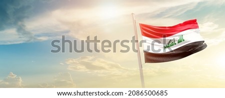 Iraq national flag waving in beautiful sky.