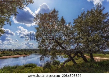 The beautiful nature of Russia. A beautiful river with trees, beaches on the shore. Beautiful clouds over the river. Great vacation on a small river in the province.