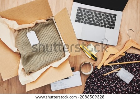 Packing online order to delivery to customer. Preparing parcel box with clothes product from online shop Royalty-Free Stock Photo #2086509328