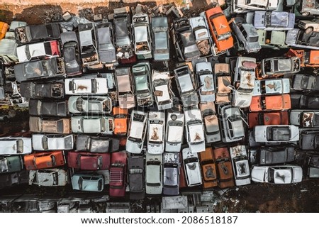 Aerial view of a Soviet automobile dump from a drone. Shooting from above at heaps of rusty cars. Abandoned Russian cars awaiting disposal and recycling Royalty-Free Stock Photo #2086518187