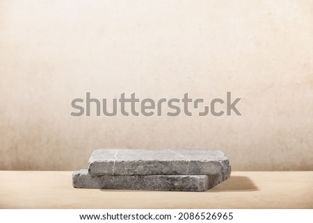 Monochrome beige template for mockup, banner. Flat granite pedestal on beige background. Stone stand for natural design concept. Horizontal image, center composition, hard light, front view Royalty-Free Stock Photo #2086526965