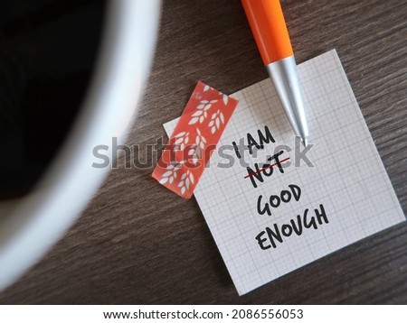 Stick note and pen with text written I AM NOT GOOD ENOUGH, changed to I AM GOOD ENOUGH, concept of overcome negative inner voice and change to positive self talk to boost self esteem Royalty-Free Stock Photo #2086556053