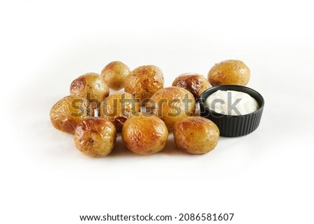 Young small potatoes baked with garlic, thyme and sea salt on white background 
 Royalty-Free Stock Photo #2086581607
