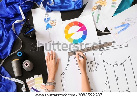 Female fashion designer working in studio, closeup