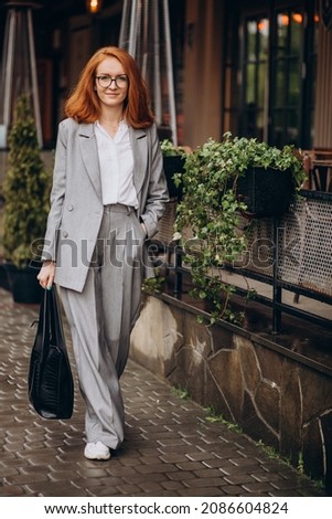 Young business woman in grey suit