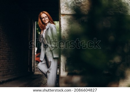 Young business woman with red hair outdoors