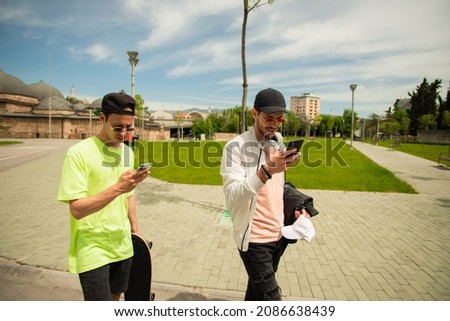 Two friends are hanging out together so they can look at their phones
