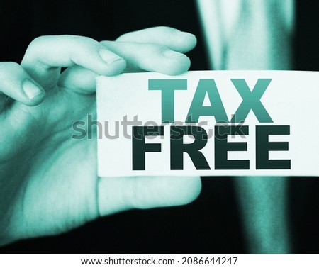 Tax free words on a card in businessman's hand. Taxes and fees regulation in business concept.