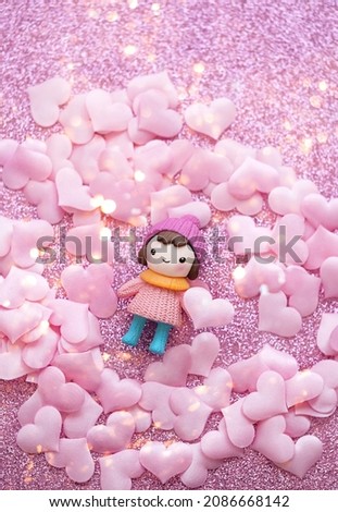 cute baby doll and pink hearts concfetti on glitter pink background. 14 february holiday, Valentine's day, Love, romance concept. top view