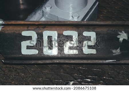 On a piece of metal paint is applied 2022.