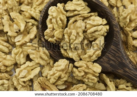 group of walnuts in wooden spoon, full frame