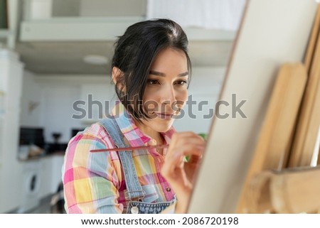 woman painting a picture at home