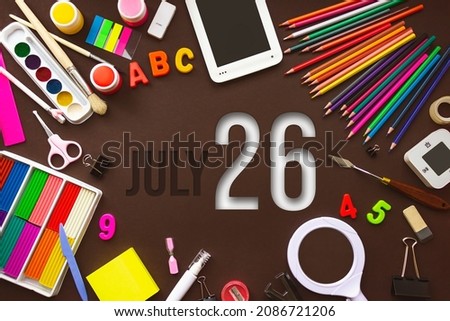 July 26th. Day 26 of month, Calendar date. School notebook and various stationery with calendar day. School and office supplies frame. Summer month, day of the year concept