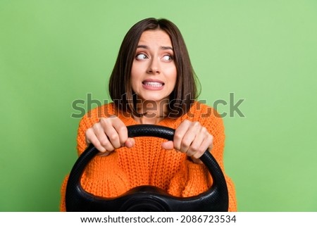 Portrait of attractive worried frustrated girl holding steering wheel rental driving learning isolated over bright green color background Royalty-Free Stock Photo #2086723534