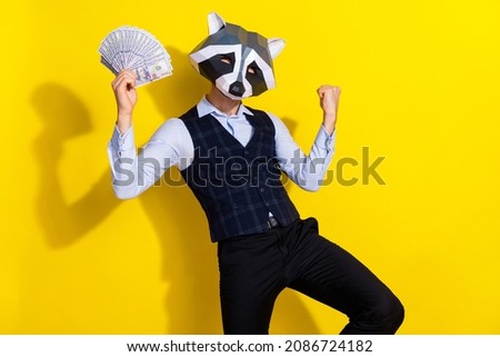 Photo of weird freak guy hold billion cashback luck win raise fists up wear trend theme costume isolated over yellow color background
