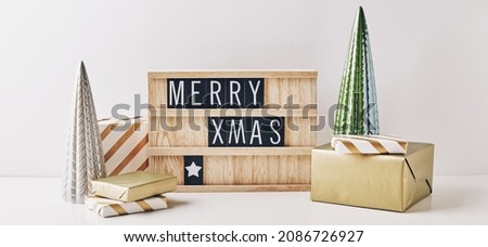 Christmas letter board spelling Merry Christmas and Happy New Year with wrapping gifts and christmas decorations. Holiday card, Christmas greetings concept