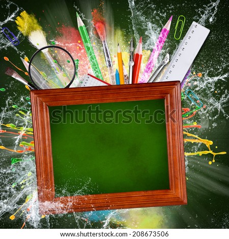 School supplies with blackboard, abstract background, close-up.