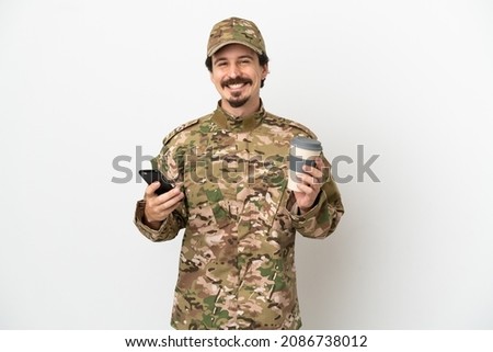 Soldier man isolated on white background holding coffee to take away and a mobile
