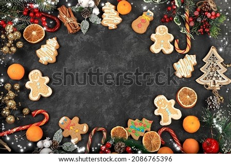 Christmas new year background, traditional festive gingerbread and tangerines with fir branches, cones and decorations, dish design idea, bakery concept, selective focus,