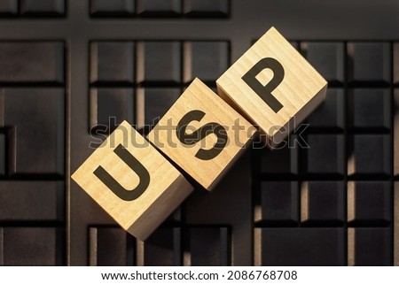 letters USP on 3d wooden cubes on a keyboard background, business concept. USP - short for Unique Selling Proposition