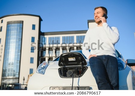 Man turning on charging of car