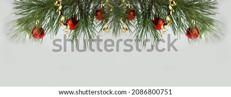 Christmas background with Christmas trees. Christmas card. Christmas tree branches and red balls. Banner. Copy space