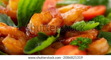 Close-up of fresh shrimp, tomato, arugula and greens salad, horizontal banner