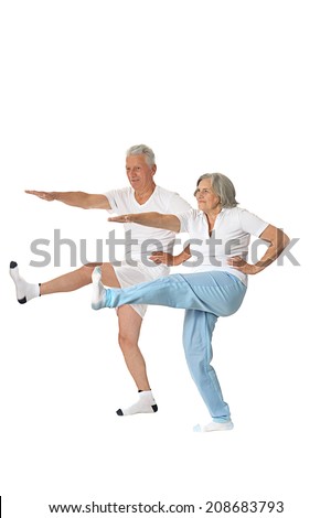 Portrait of senior couple exercising on a white background