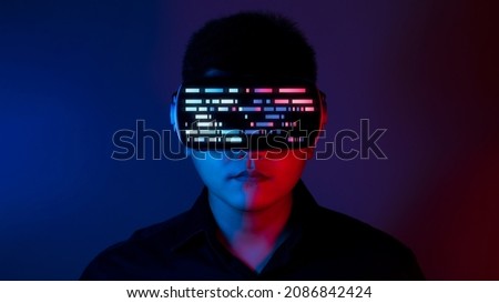 Young man wearing VR goggles. Metaverse technology virtual reality concept. Virtual Reality Device, Simulation, 3D, AR, VR, Innovation and Technology of the Future on Social Media. Royalty-Free Stock Photo #2086842424