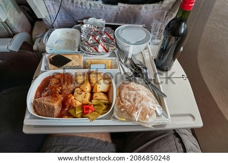Airplane food provided on a long distance transatlantic flight Royalty-Free Stock Photo #2086850248