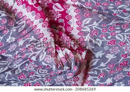 Woven textile fabric with floral motifs in white blue and red