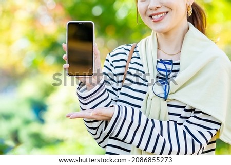An anonymous female operating a smartphone