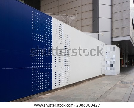 Blank empty construction hoarding space for advertisement mockup. Construction site area in the CBD.