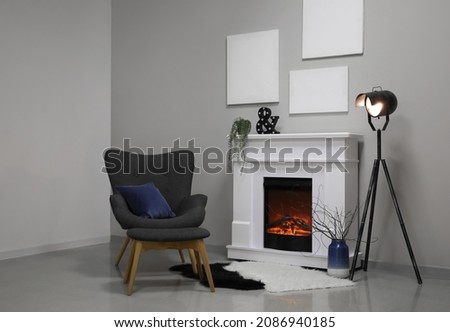 Interior of modern living room with fireplace and armchair