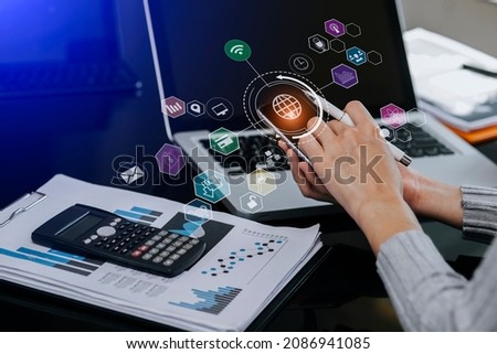 Double exposure of businesswoman hand touch on tablet with laptop and business financial virtual chart, Digital marketing concept. 