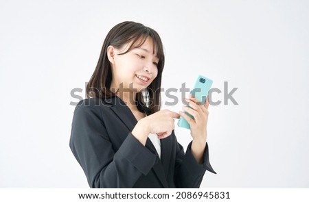 Asian businesswoman using the smartphone in white background