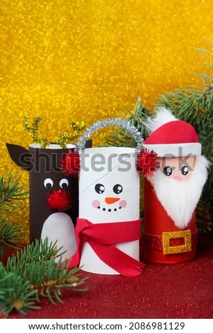 Handmade craft project from toilet tube. Creative kids DIY New year. Cute Snowman, Deer, Santa Claus for Christmas party. Vertical picture