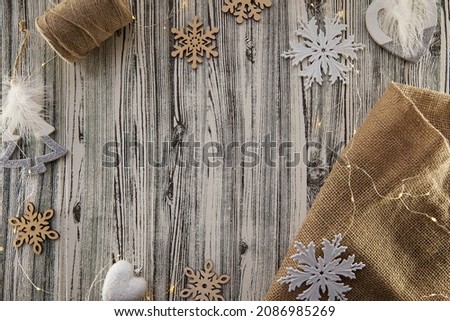 Organic design of Christmas background. Wooden and textile crafting ornaments and modern white fluffy decorations. Copy space. High quality photo