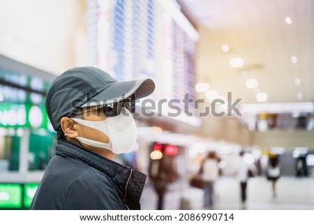 Facemasks prevent COVID-19 virus, Asian older or glasses senior smart woman tourist hipster with backpack walking to travel at arrival international airport, Lifestyle traveler holiday by airplane Royalty-Free Stock Photo #2086990714