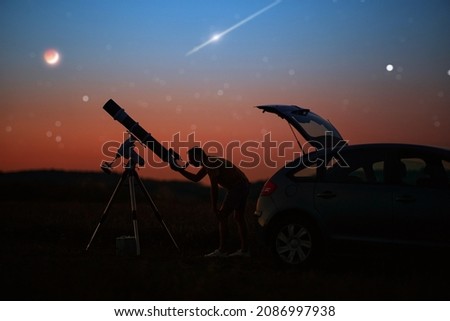 Silhouette of a man, car, telescope and countryside under the starry skies.