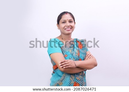 Indian rural happy villager woman standing in saree on a white background. Royalty-Free Stock Photo #2087026471